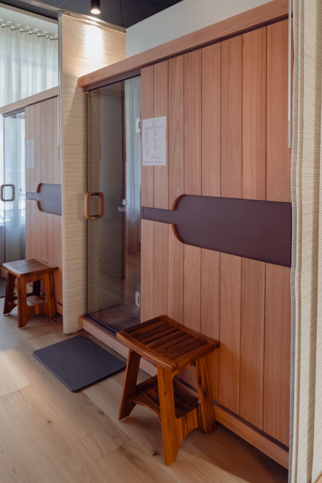 Wood-panelled infrared sauna suites with teak stools
